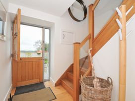 An entrance hall with a staircase and front door at The Dairy in 