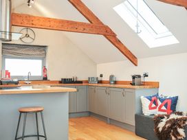 A kitchen with wooden beams and a skylight at The Dairy in 