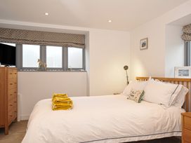 A bedroom with a bed and a chest of drawers at The Dairy in 