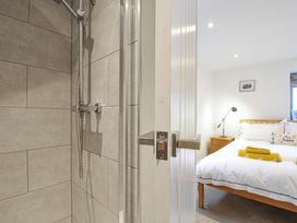 A shower area with tiles and a bedroom visible at The Dairy 