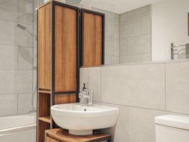 A bathroom with a sink, toilet, and bathtub at The Dairy in 