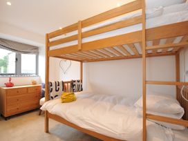 A bedroom with a bunk bed and a dresser at The Dairy