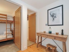 A bedroom with a bunk bed and wooden table at The Dairy in 