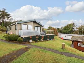 A house with a deck and plants outside at The Hideaway in Pwllheli