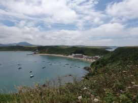 A coastal view with boats on water and houses by the beach at The Hideaway Pwllheli
