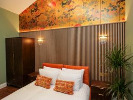 A bedroom with a bed and decorative elements at The Studio in Windermere