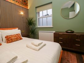 A bedroom with a bed and dresser at The Studio in Windermere