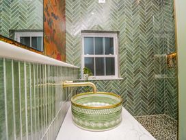 A bathroom with a sink and window at The Studio in Windermere