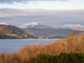 A view of a lake with mountains and trees at The Studio in Windermere