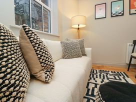 A living room with a sofa and cushions at The Coach House in Windermere