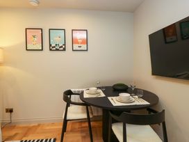 A dining room with a round table and chairs at The Coach House in Windermere