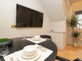 A dining room with a table set for meals at The Coach House in Windermere