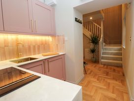 A kitchen with cabinets and sink at The Coach House in Windermere