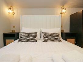 A bedroom with a bed and bedside tables at The Coach House in Windermere