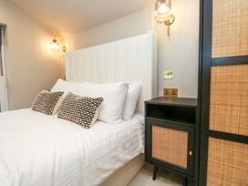 A bedroom with a bed and bedside table at The Coach House in Windermere
