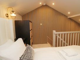 A bedroom with a bed and a lamp at The Coach House in Windermere