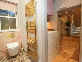 A bathroom with a toilet and towel rail at The Coach House in Windermere