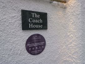 A property name sign and holiday home plaque at The Coach House in Bowness-On-Windermere