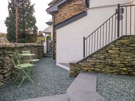 An outdoor area with chairs and gravel at The Coach House in Bowness-On-Windermere