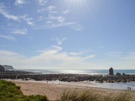 A beach with rocky formations and ocean at 8 Thurlestone Rock in Kingsbridge