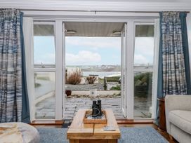 A living room with sliding doors and a view at 8 Thurlestone Rock in Kingsbridge