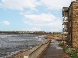 A coastal view with a building and pathway at 8 Thurlestone Rock in Kingsbridge