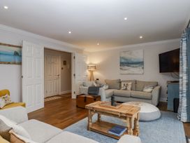 A living room with a sofa and coffee table at 8 Thurlestone Rock in Kingsbridge