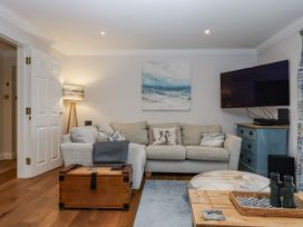 A living room with a sofa and a television at 8 Thurlestone Rock in Kingsbridge