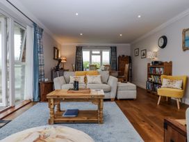 A living room with a sofa and coffee table at 8 Thurlestone Rock in Kingsbridge