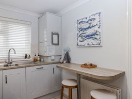 A kitchen with sink and bar seating at 8 Thurlestone Rock in Kingsbridge