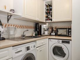 A laundry room with appliances and a sink at 8 Thurlestone Rock in Kingsbridge
