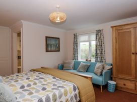 A bedroom with a bed and a couch at 8 Thurlestone Rock in Kingsbridge