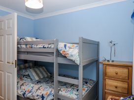 A bedroom with a bunk bed and a bedside table at 8 Thurlestone Rock in Kingsbridge