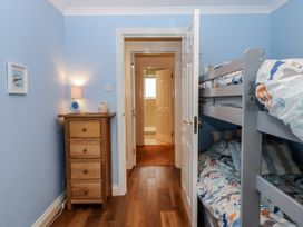 A bedroom with a bunk bed and nightstand at 8 Thurlestone Rock in Kingsbridge