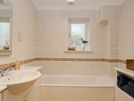 A bathroom with a bathtub and sink at 8 Thurlestone Rock in Kingsbridge