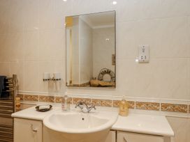 A bathroom with a sink and mirror at 8 Thurlestone Rock in Kingsbridge