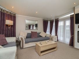 A living room with a sofa and coffee table at Whistler in Wimborne