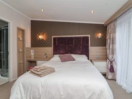 A bedroom with a bed and bedside table at Whistler in Wimborne