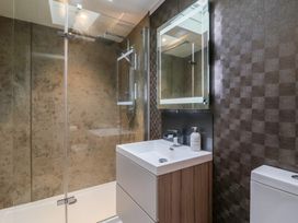 A bathroom with a shower and vanity at Whistler in Wimborne