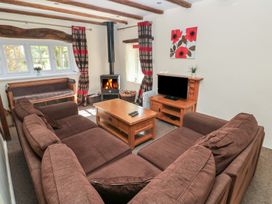 A living room with a sofa and television at Carthouse Cottage in Clarbeston Road