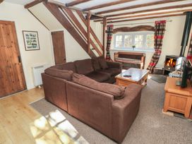 A living room with a sofa and coffee table at Carthouse Cottage in Clarbeston Road