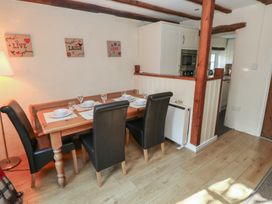 A dining area with a table and chairs at Carthouse Cottage Clarbeston Road