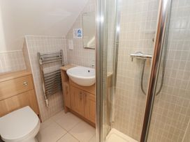 A bathroom with a shower and wash basin at Carthouse Cottage in Clarbeston Road