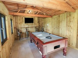 A snug with a billiard table and bar stools at Carthouse Cottage in Clarbeston Road