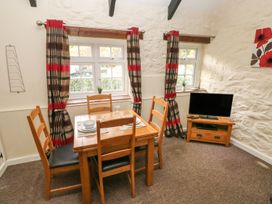 A dining area with a table and chairs at Corner Cottage in Clarbeston Road