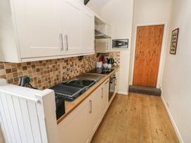 A kitchen with cabinets and appliances at Corner Cottage in Clarbeston Road