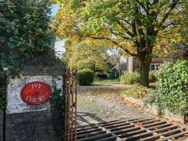 A view of the entrance gate and path surrounded by trees at Ivy Court in Clarbeston Road