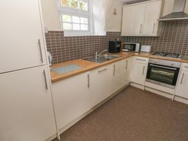 A kitchen with cabinets and appliances at Stable Cottage in Clarbeston Road