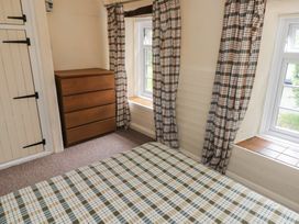 A bedroom with a bed and a dresser at Stable Cottage Clarbeston Road