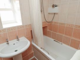A bathroom with a bathtub, sink, and shower at Stable Cottage in Clarbeston Road